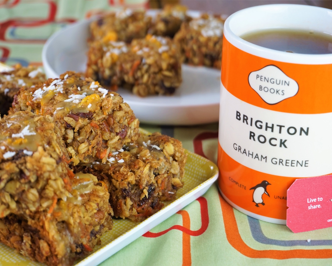 carrot cake oat bars on a tray with a cup of tea