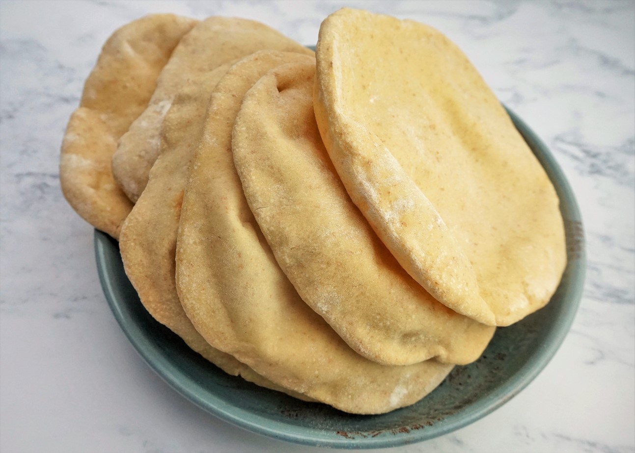 stack of homemade pitta bread in a bowl