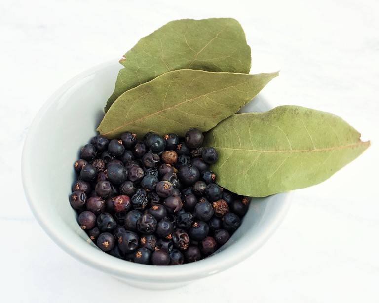 a bowl of juniper berries and bay leaves
