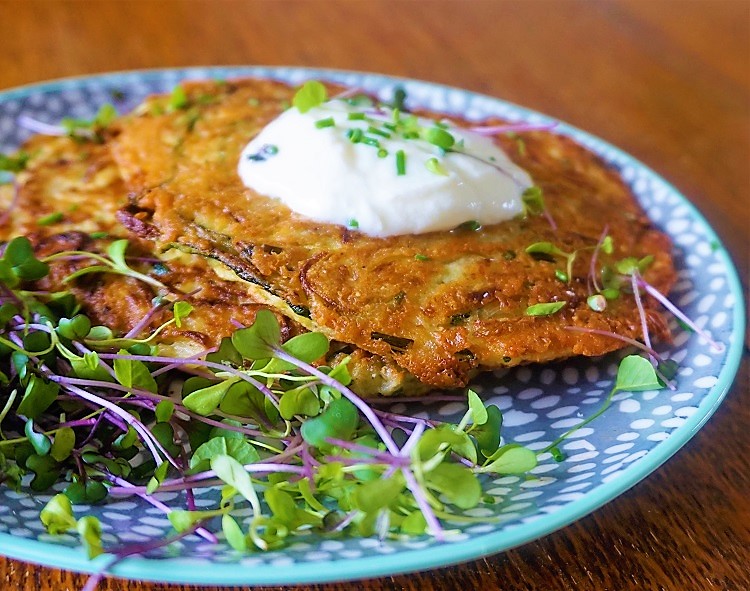 courgette & chive pancakes with micro leaf salad and topped with yogurt and chives