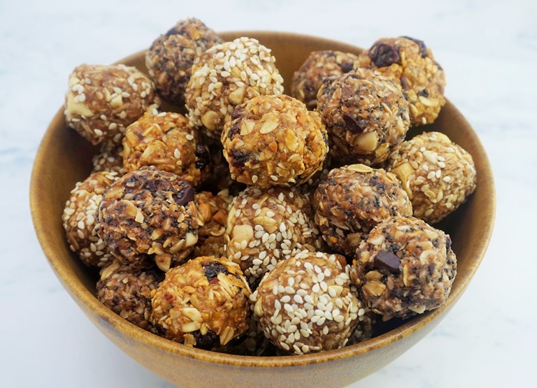 a bowl of oat bites in three different flavours