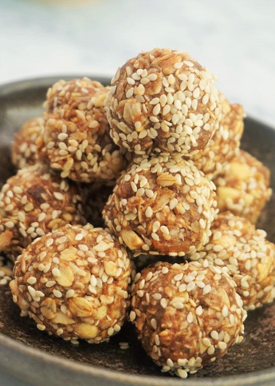 a bowl of tahini and apricot oat bites