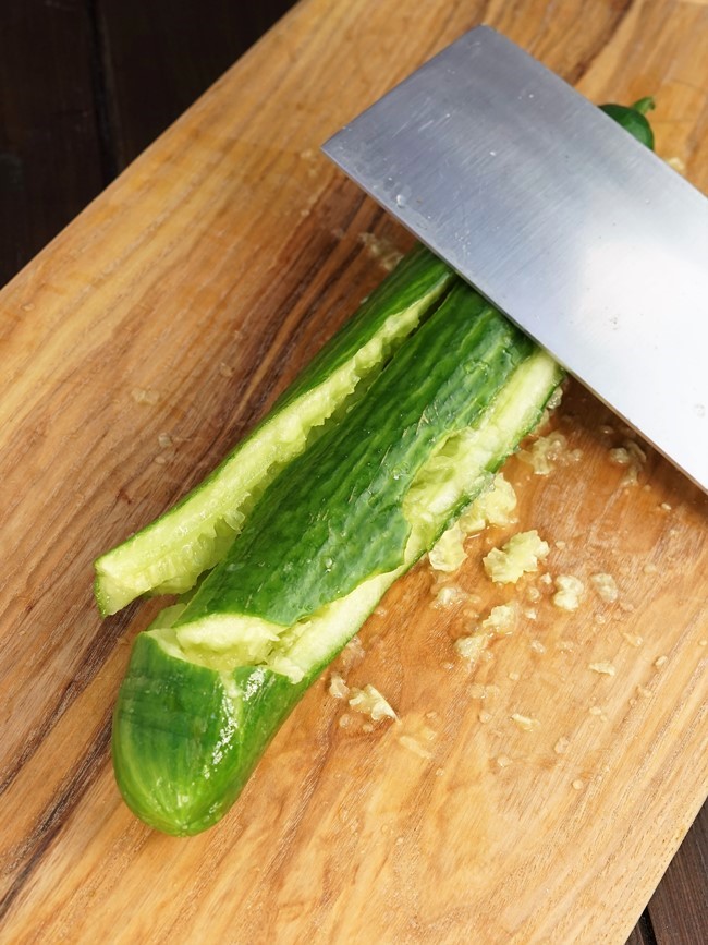 making smacked cucumber with chilli oil