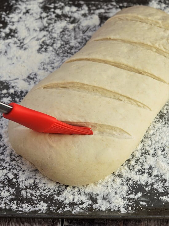 brushing water into Bloomer Bread dough slashes