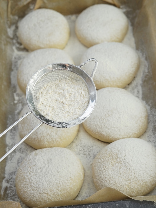 dusting soft white baps with flour before baking