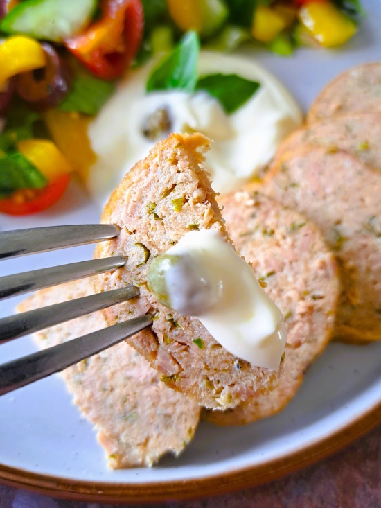 eating Italian Tuna Loaf or polpettone di tonno with mayonnaise and capers