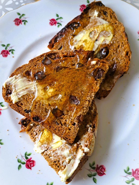 Spiced Fruit bread sliced, toasted, spread with butter and drizzled with honey