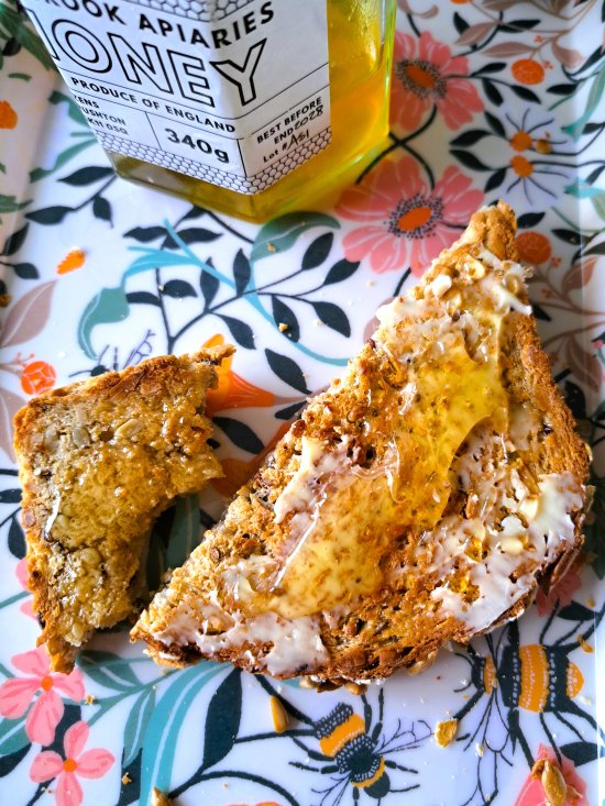 Sunflower, Honey and Oat Bread toasted and spread with butter and honey
