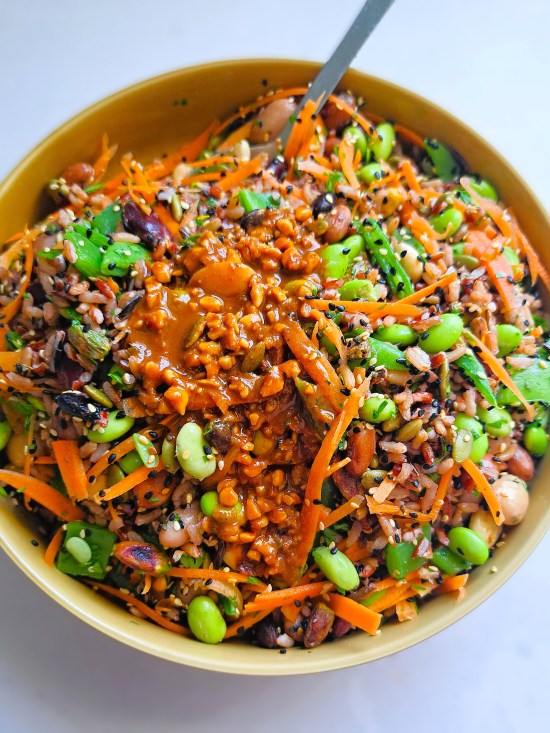 adding dressing to Nutty Wholefood Grain Salad